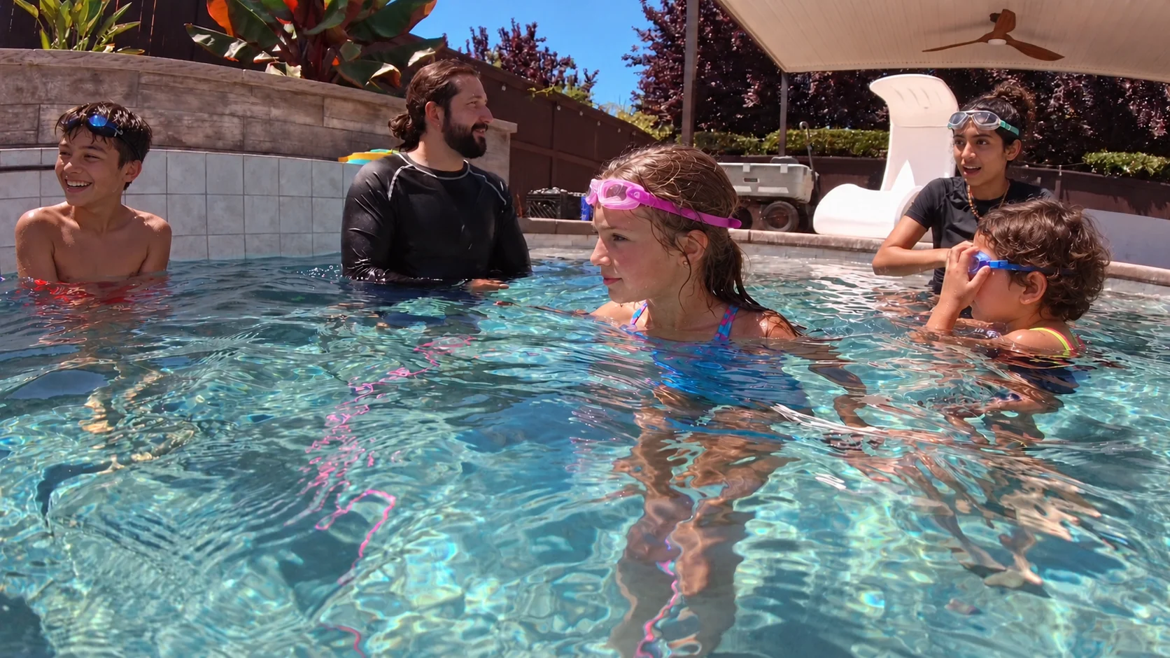 Rich leads a small-group swim lesson. Children’s appearances have been digitally altered for privacy.